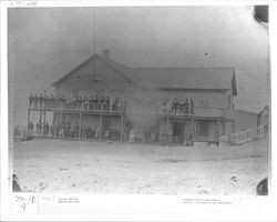 People standing on the porch of a hotel