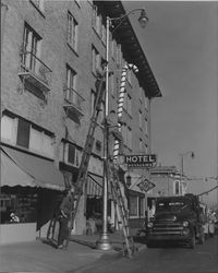 City crews installing Christmas decorations along lamp posts, Petaluma, California, 1945