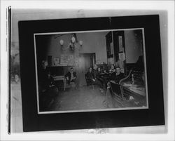 Four people sitting in an office, Petaluma, California, 1890