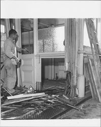 Workman tearing out the interior of the McNear Building at 212 Petaluma Boulevard North, Petaluma, California, about 1962