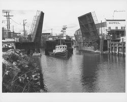 Tugboat "Golden Eagle" towing a barge underneath the Washington Street bridge, Petaluma, California, about 1938