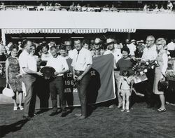 Fair officials and racetrack enthusiasts holding Humboldt Co. Fair Purse banner at the Sonoma County Fair, Santa Rosa, California, 1967