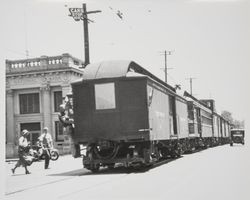 Last train from Forestville to Sebastopol hauling passenger cars to Petaluma on Main Street, Sebastopol, 1931