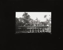 View of unidentified bridge under construction with old bridge in background