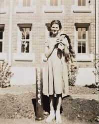 Mary Margaret Thompson standing in front of a building on the Santa Rosa High School campus, Santa Rosa, California, about 1940