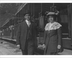 Walter and Sadie Neil standing next to a railway car, about 1908