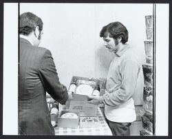 Showing a customer a gift box of Sonoma Jack Cheese and wine, Sonoma, California, 1972