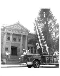 Petaluma Fire Department aerial truck in front of the Carnegie library, Petaluma, California, 1961