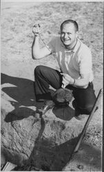 Jim Carlson dipping into the Old Adobe Fiesta barbecue pit, Petaluma, California, 1962