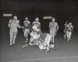 Run play during Petaluma Leghorn game against San Jose