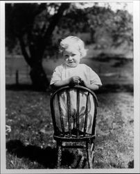 Small child kneeling on a chair at the Lytton Home, Lytton, California, 1921