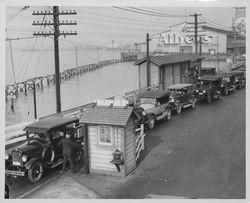 Line of automobiles waiting at the toll station on the Oakland Pier, Oakland, California, 1927