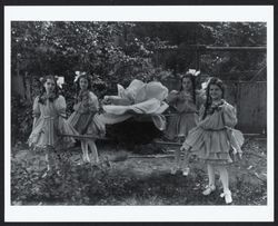 Girls carrying giant fabric rose