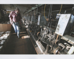 John Agnew inspecting machinery inside the Sunset Line & Twine Company building in Petaluma, California, on his last day, Dec. 22, 2006