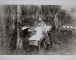 Fred L. Volkerts, Jr. seated on a box at a US Marine Corps camp during World War II, likely Camp Pendleton, California, about 1942