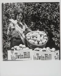 Apple Blossom Queen Julie Pimental posing with apple products, Sebastopol, California, 1977