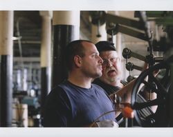 Russell Strickland and "Big" Dennis Henderson standing next to a braider machine on the first floor of the Sunset Line & Twine Company building in Petaluma, California, Dec. 2006