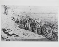 Work crew removing rocks from a small hill