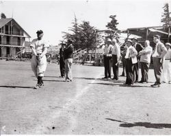 Oscar Vitt, instructor with the San Francisco Examiner Baseball School, with spectators, at McNear Park, Petaluma, California, July 1954