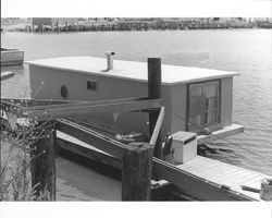 Houseboat tied up at a dock in the Turning Basin