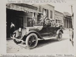 William S. Borba in the back seat of a roadster decorated with California state flags