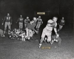 Run play during Petaluma Leghorns game against San Jose