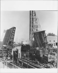 Pile driver on a barge working on the Washington Street Bridge replacement, Petaluma, California, 1968