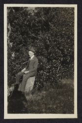 Charles R. Drake sitting on a tree stump, Sonoma County, California, 1920s