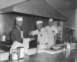 Men serving pancakes in an unidentified restaurant, Petaluma, California, about 1953