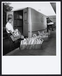 Al Lafranconi and Marcus Fok loading North Bay Cooperative Library System's delivery van