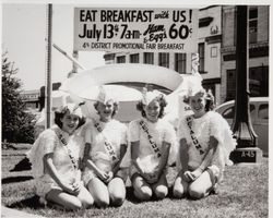 Slick Chicks gather around a frying pan and egg to promote the 4th District Agricultural Fair breakfast on July 13, 1947 in Petaluma, California