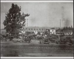 Crowd of people, cars, and wagons surrounding Chanticline the chicken., Lakeville and East Washington streets, Petaluma, California, 1921
