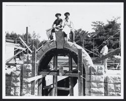 Workers sitting atop the keystone of the Healdsburg Grammar School building under construction in Healdsburg, California, 1906