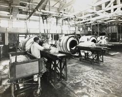 Three unidentified man making butter at the Petaluma Cooperative Creamery, about 1930