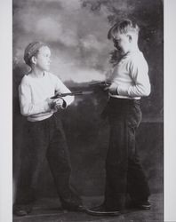 Thomas Herbert Ware and Bobby Mennter play cops and robbers in a photography studio, Santa Rosa, California, about 1930