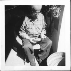 William Borba examining an Indian basket, Santa Rosa, California, 1963