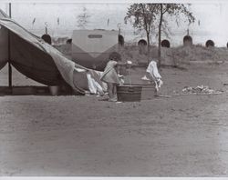 Young girl at her hop picking camp site near Wohler Road, Healdsburg, California, in the 1920s