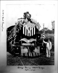 Victory bond promotion man standing next to a decorated locomotive