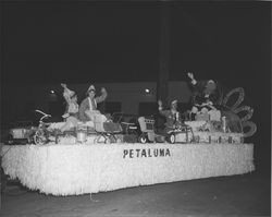 Santa Claus riding in a float filled with toys, Petaluma, California, about 1958