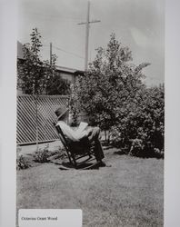 Octavius G. Wood reading in his yard, Petaluma, California, 1940s