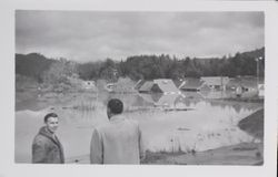 Men gazing at a flooded Guerneville