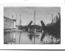 Tug towing a barge under the D Street drawbridge, Petaluma, California, about 1925