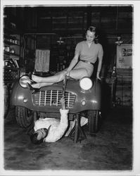 Diane Romero, Miss Sonoma County posing atop a foreign sports car for S.C.C.A. race publicity, Santa Rosa, California, 1957
