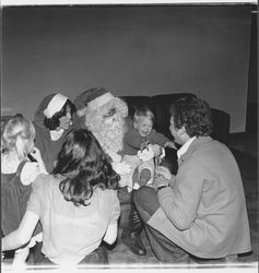 Santa Claus and children at a National Controls Christmas party, Santa Rosa, California, 1979