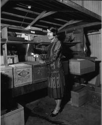 Nora Lamburth Rossi holding three eggs from a box of Fancy White Nulaid Premiums from the Poultry Producers of Central California1924