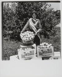 Apple Blossom Queen Julie Pimental posing with apple products, Sebastopol, California, 1977