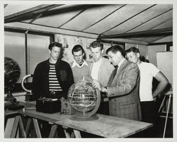 Boys examining a globe