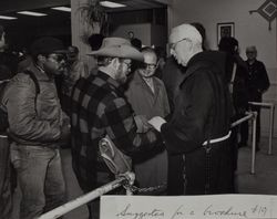 Fr. Boeddeker greets dining room guests, 121 Golden Gate Avenue, San Francisco, California, about 1979