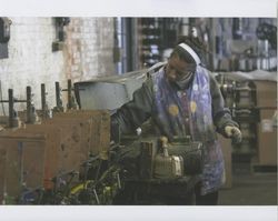 Rosa Cordova working on the paint machine at Sunset Line & Twine Company in Petaluma, California, Dec. 5, 2006