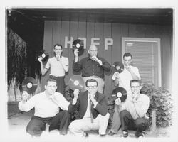 Men holding recordings outside radio station KAFP, Petaluma, California, 1957